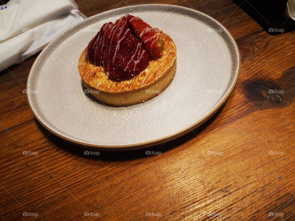 Delicious strawberry cake served with both cup of coffee