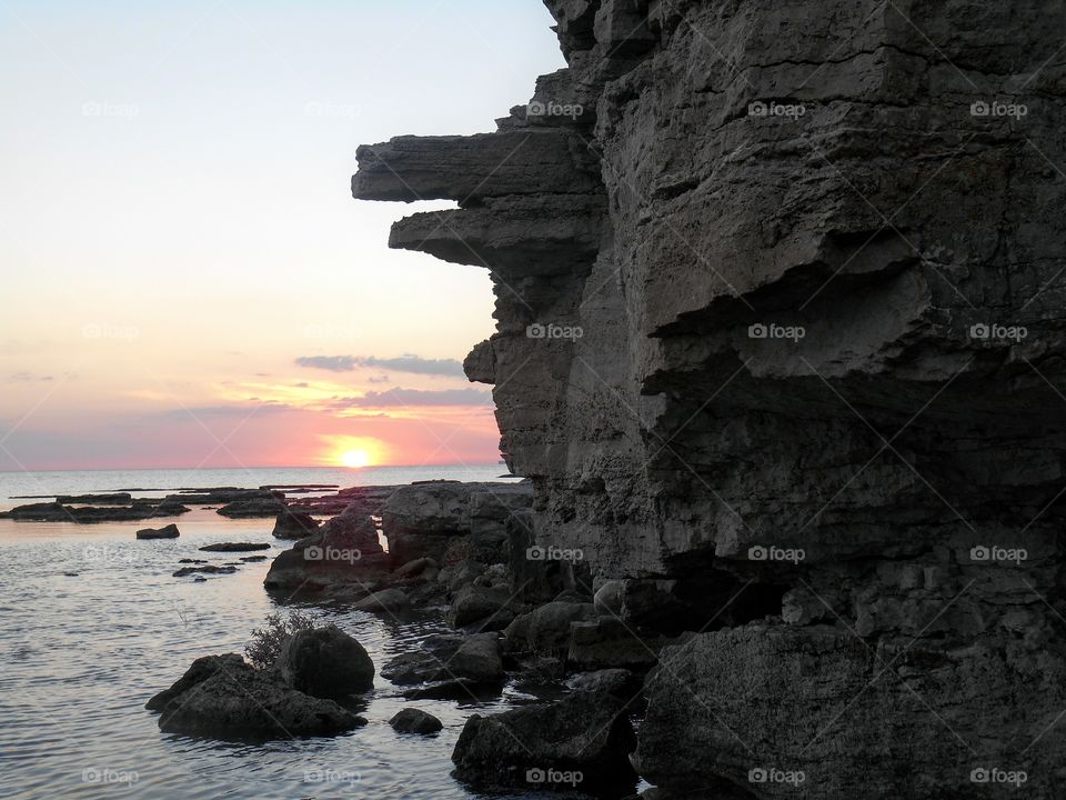 sunset on a sea shore and stones art nature