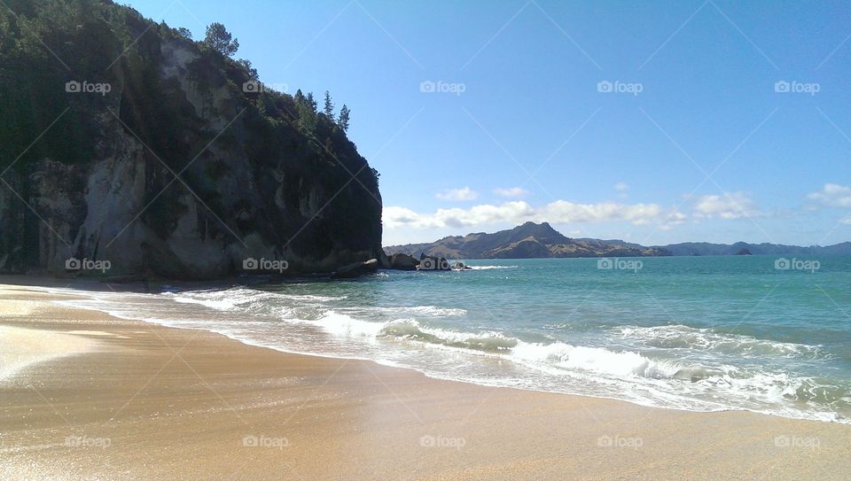 Cliff at seashore with surf