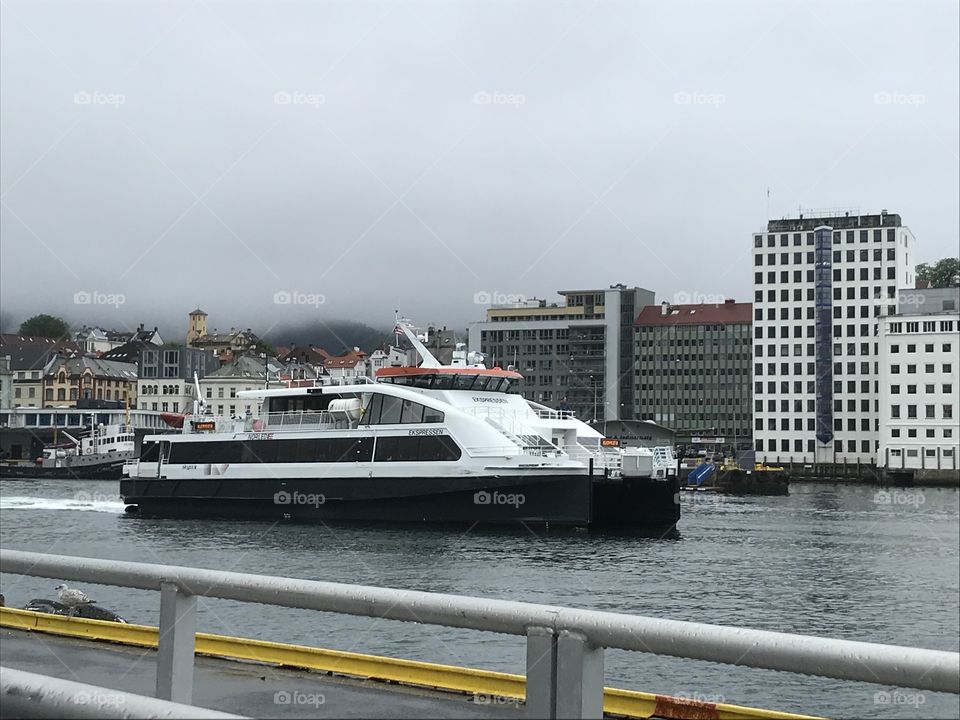 Admiralaen, one of the fast moving ferries in Bergen, norway leaving port. It’s a big fast moving ferry, capable of around 37.5 knots. The weather this day was foggy and grey.