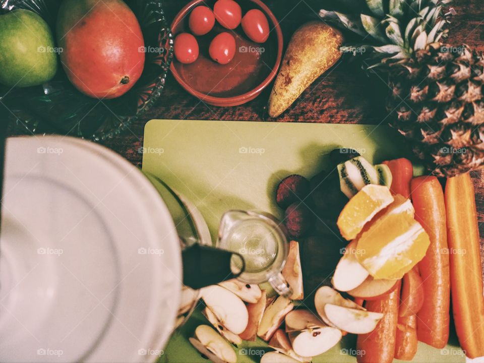 Flat lay view of fruit and vegetables cut in pieces for juicing