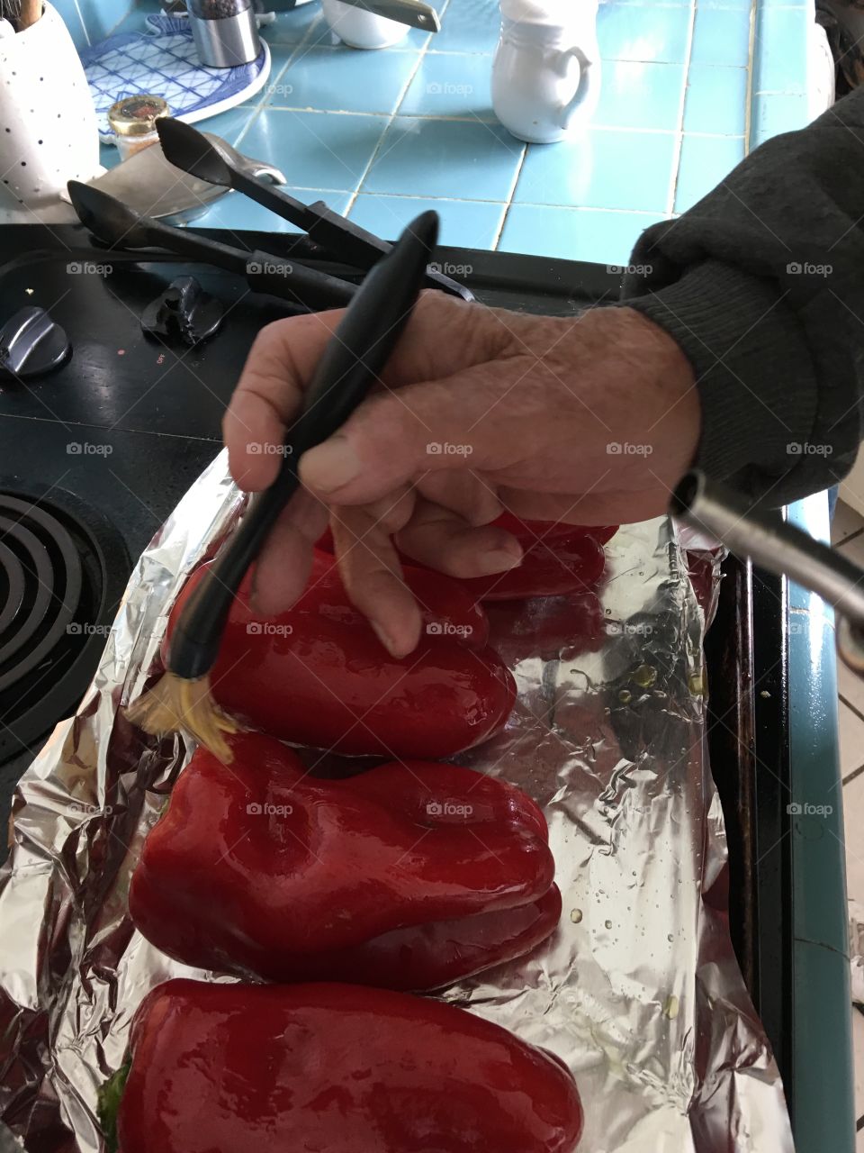 Brushing peppers with olive oil