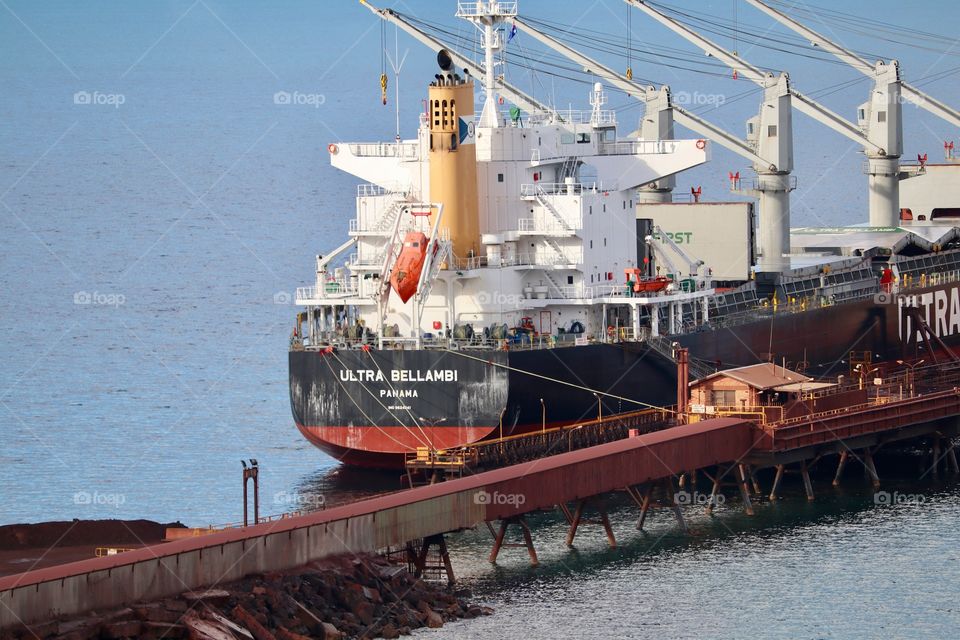 Panama registered cargo ship at steel iron ore mill loading dock 