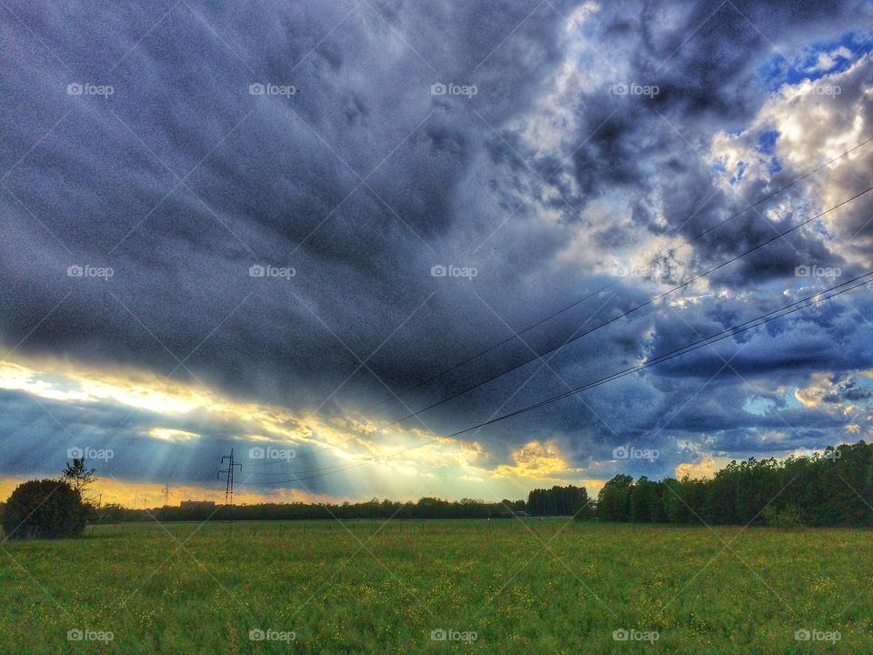 Thunderstorm and sun rays on the countryside 