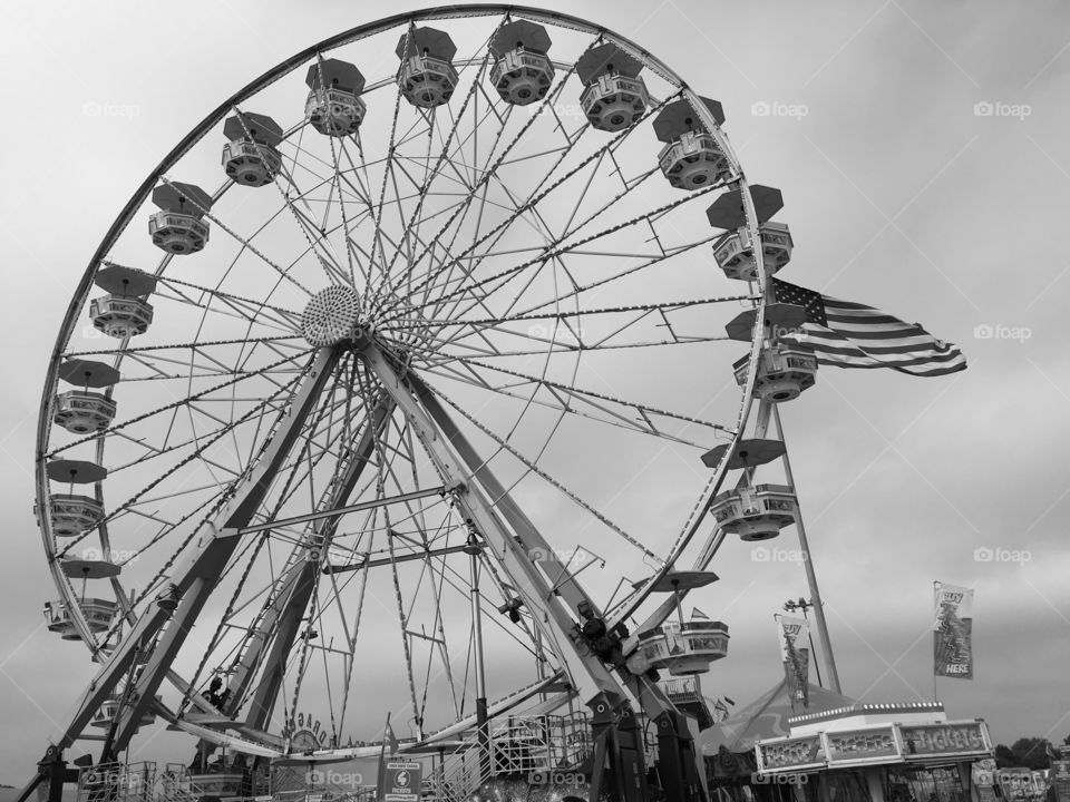 My world in black and white a Ferris wheel has lost its color an American flag still flies 