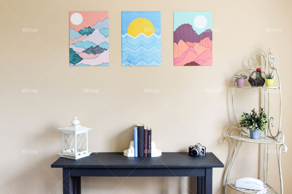 Graphic wall art displayed above a table and shelving