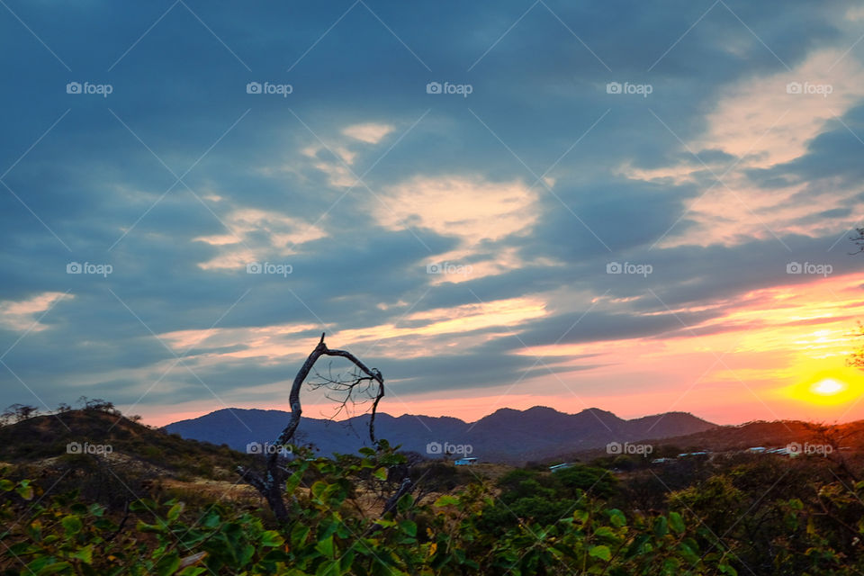 Sunset with red and blue skies with dark horizon