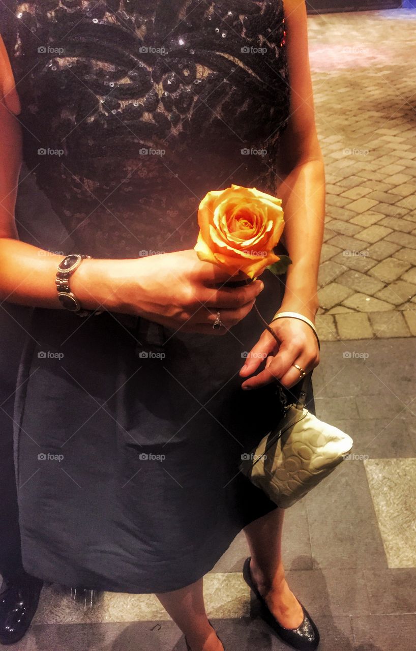Date a night. A woman holding a rose