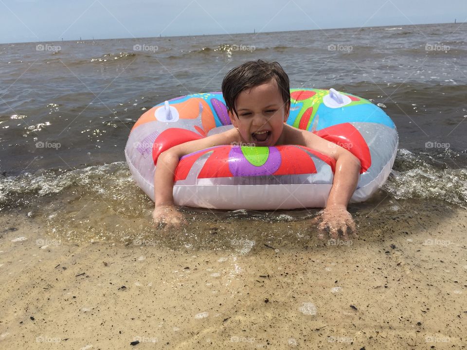 Little boy playing in ocean