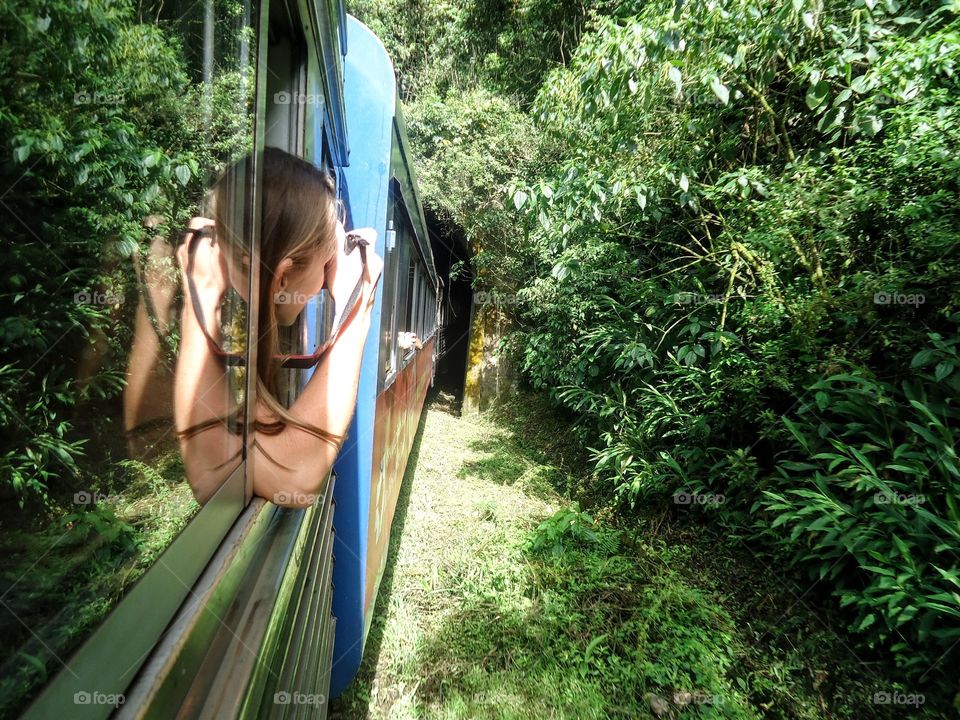 Pleasure moment -Woman traveling by train and photographing the nature