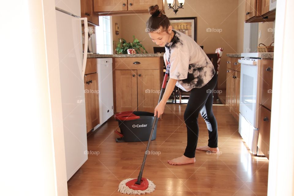 Girl using O-Cedar mop and bucket 