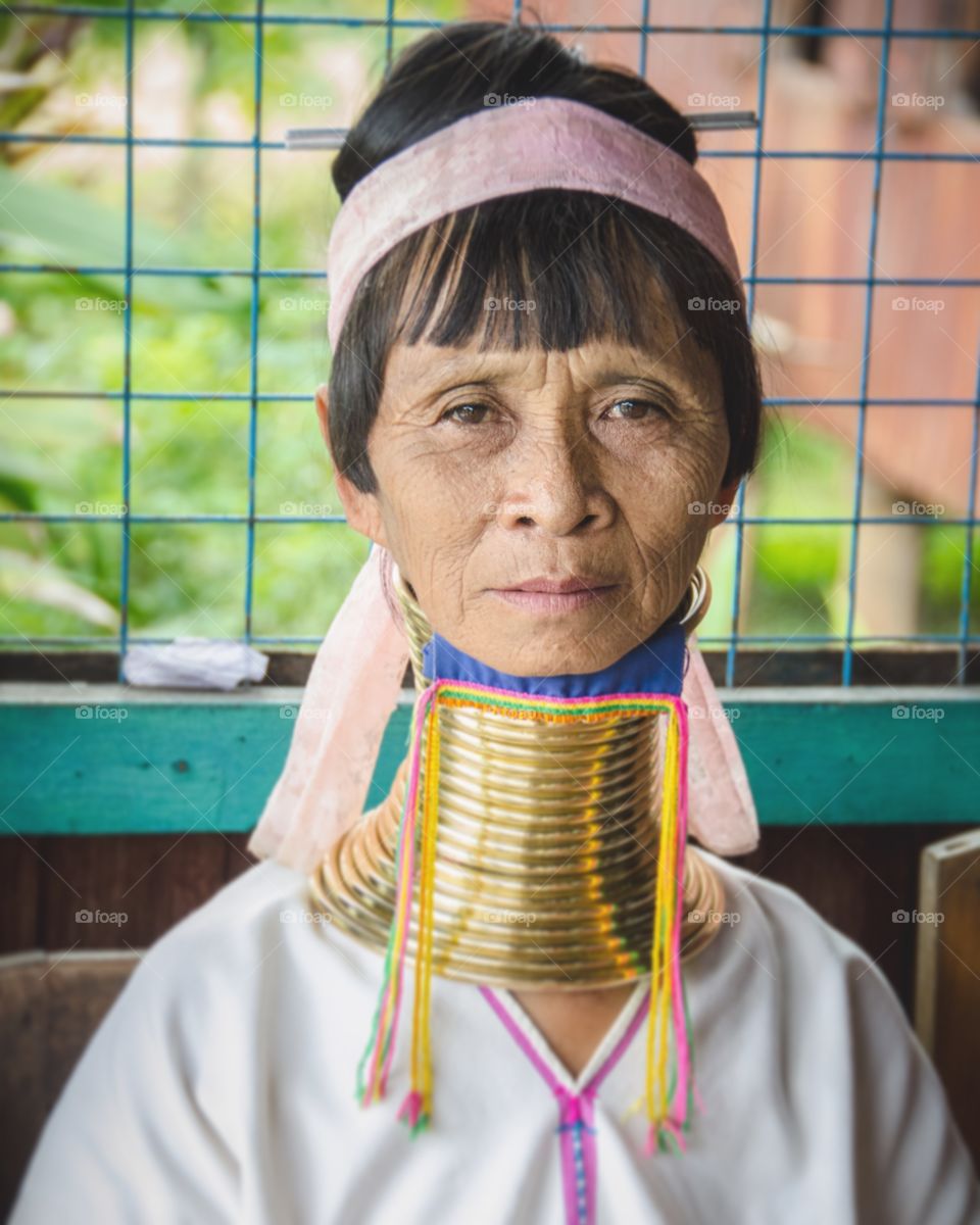 Portrait of a senior woman wearing brass ring around her neck