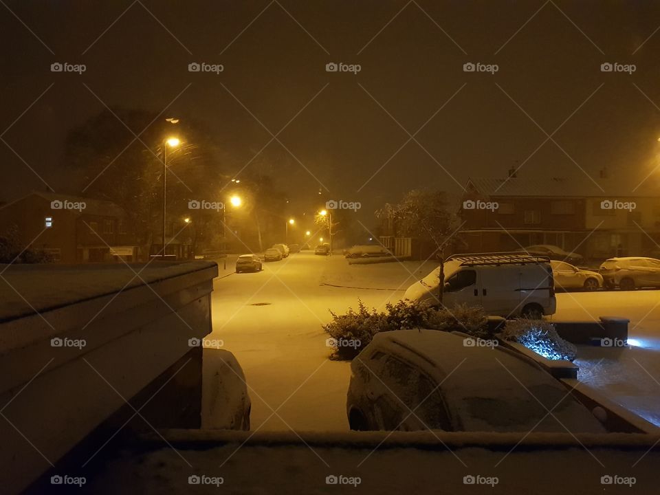 snowy wintery street at night