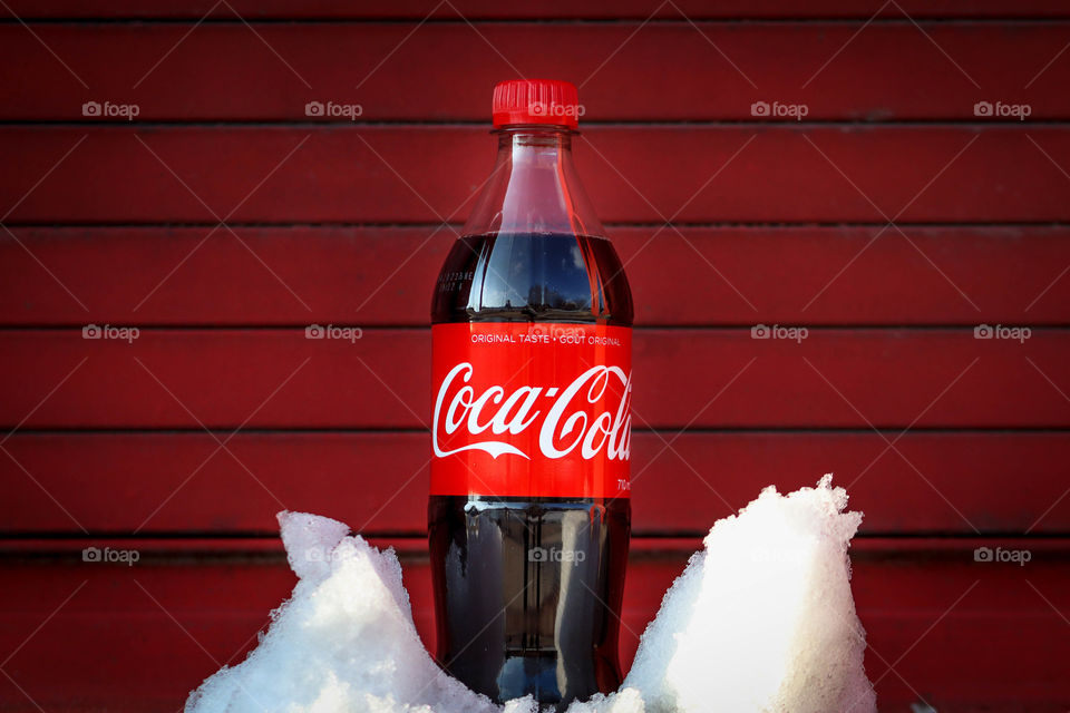 Bottle of a Coca-Cola on a red background