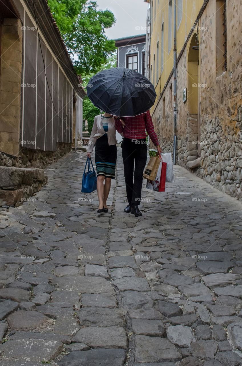 Under the rain... The Best husband. Kind, considerate and responsible. Always to his wife, ready to help.