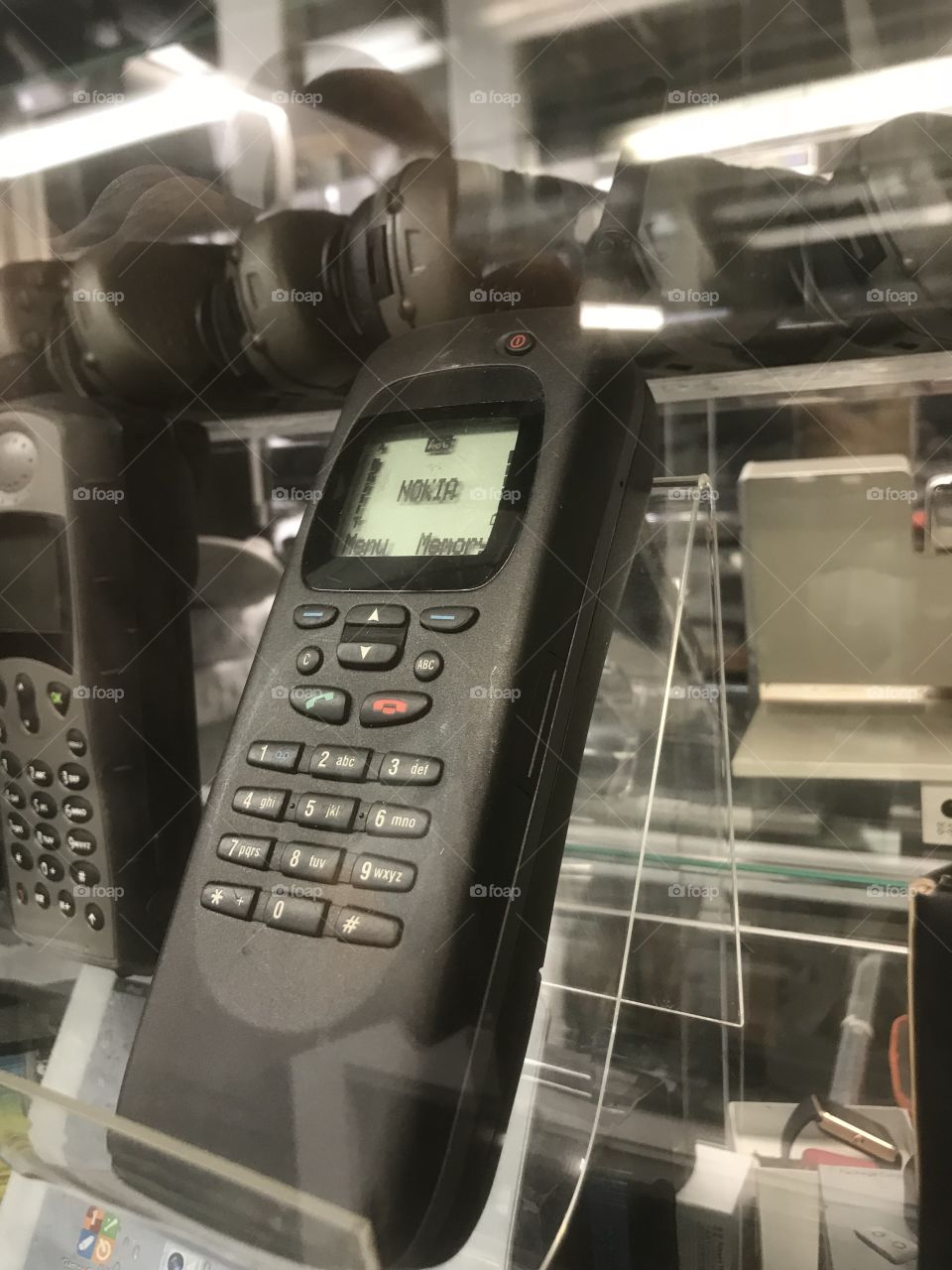 Vintage cellular telephone display. Old black brick style cel phone