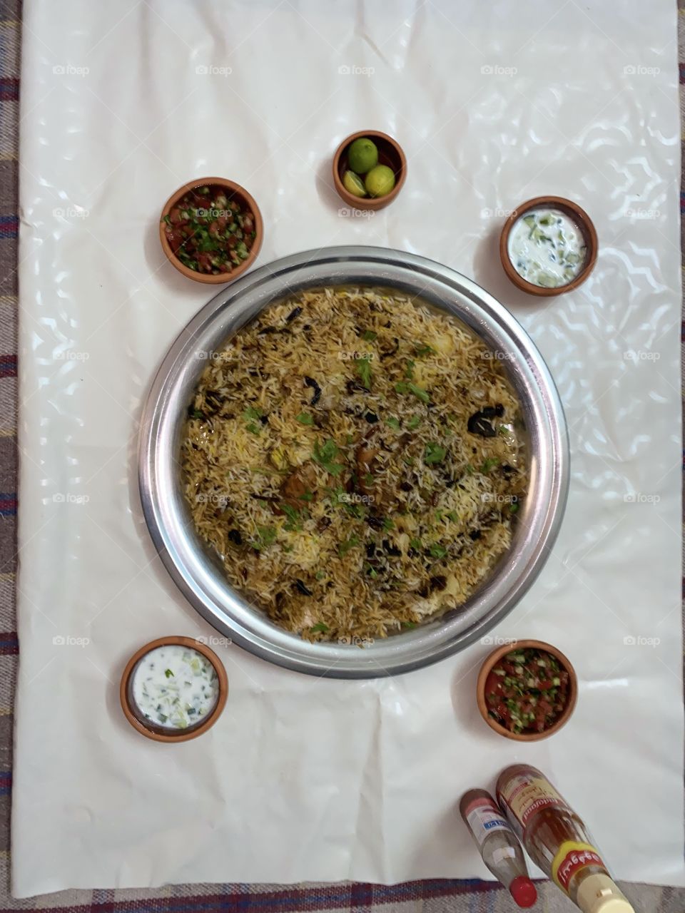 Upside-down kabsa with nuts, tomato and cucumber salad, yogurt and cucumber salad
