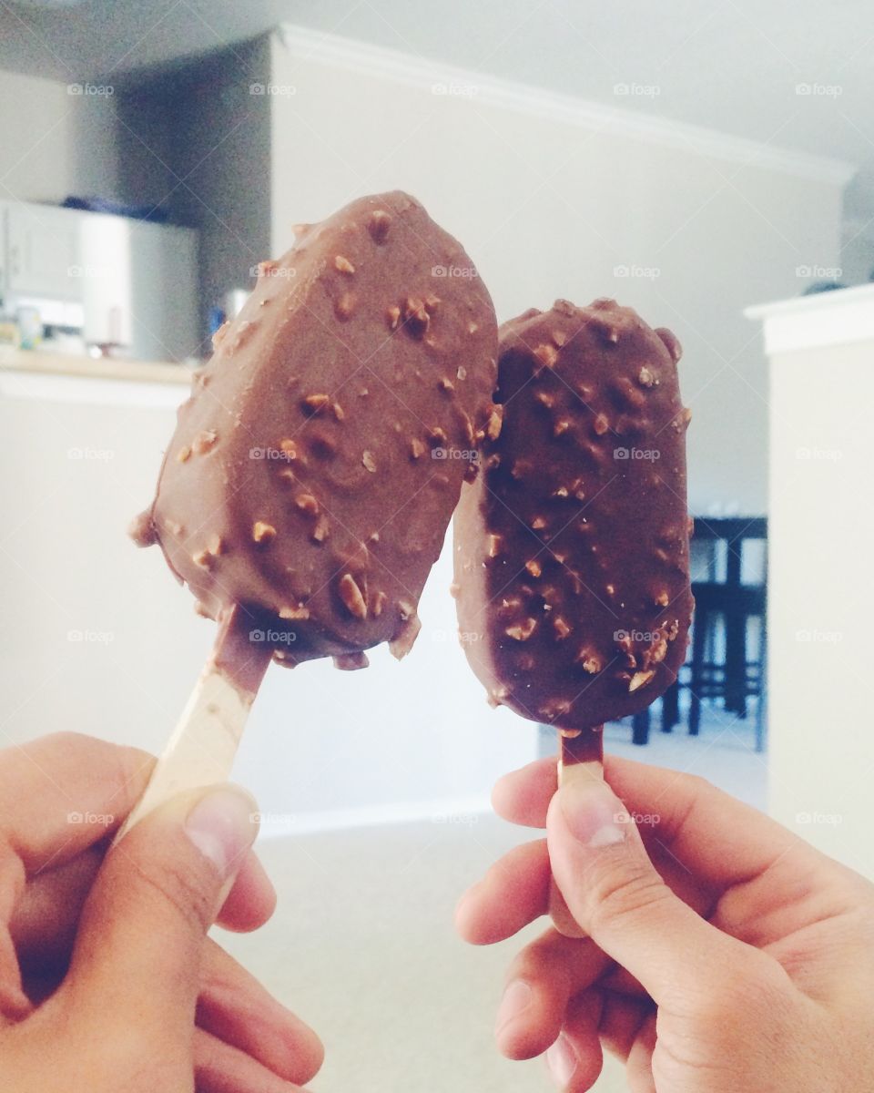 Hand holding ice cream bar