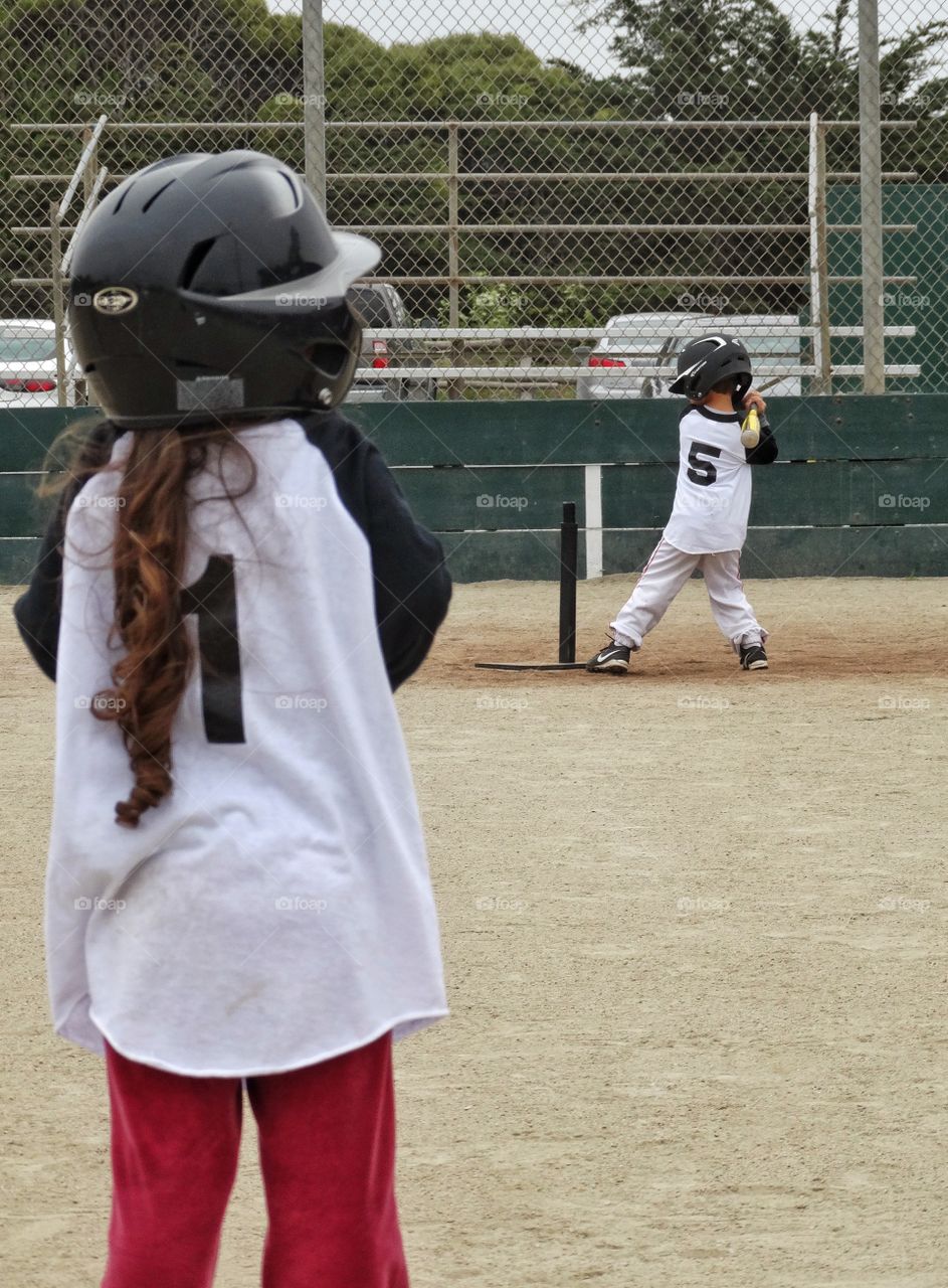Young Baseball Players. Boy And Girl Playing Little League Baseball
