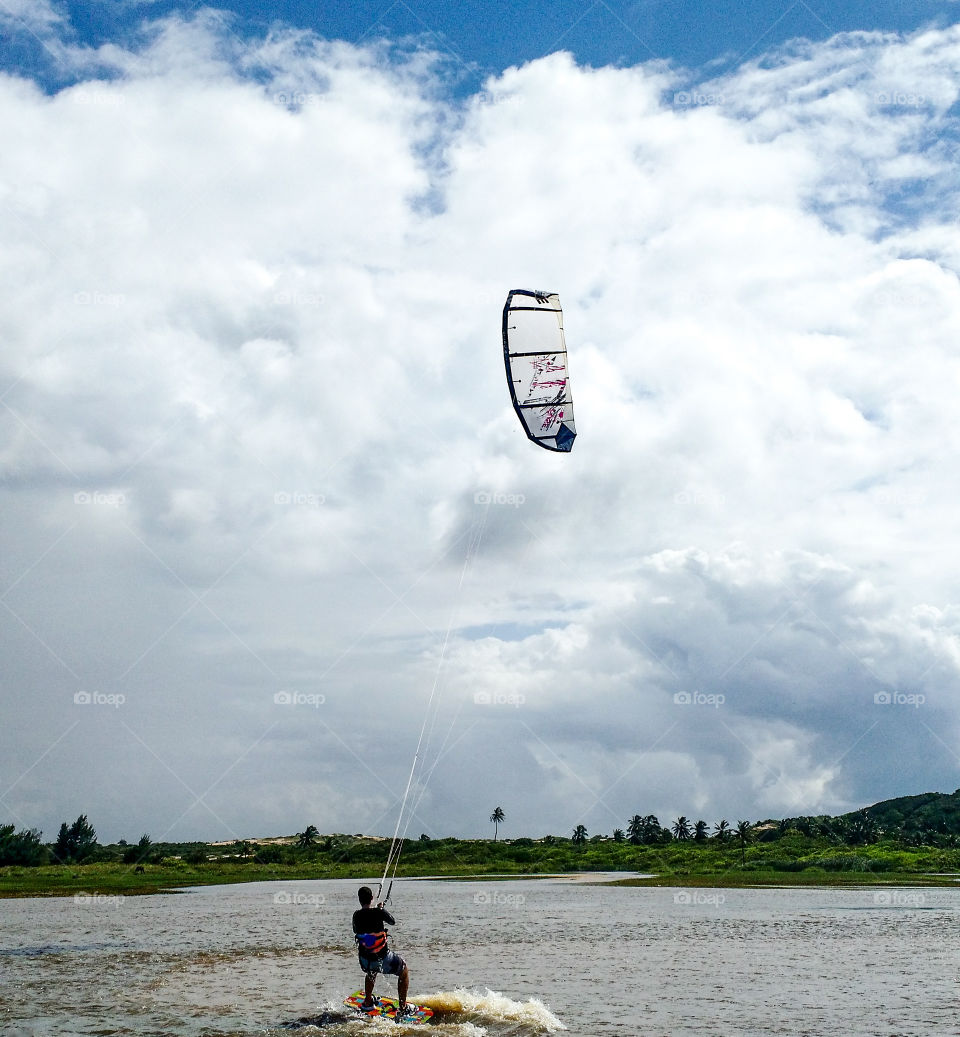 Man practicing kitesurfing in the lagoon of Icapuí
