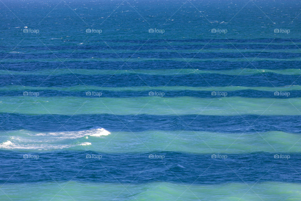 Light and shadows. Stripes in the sea from shadows casted from the buildings.