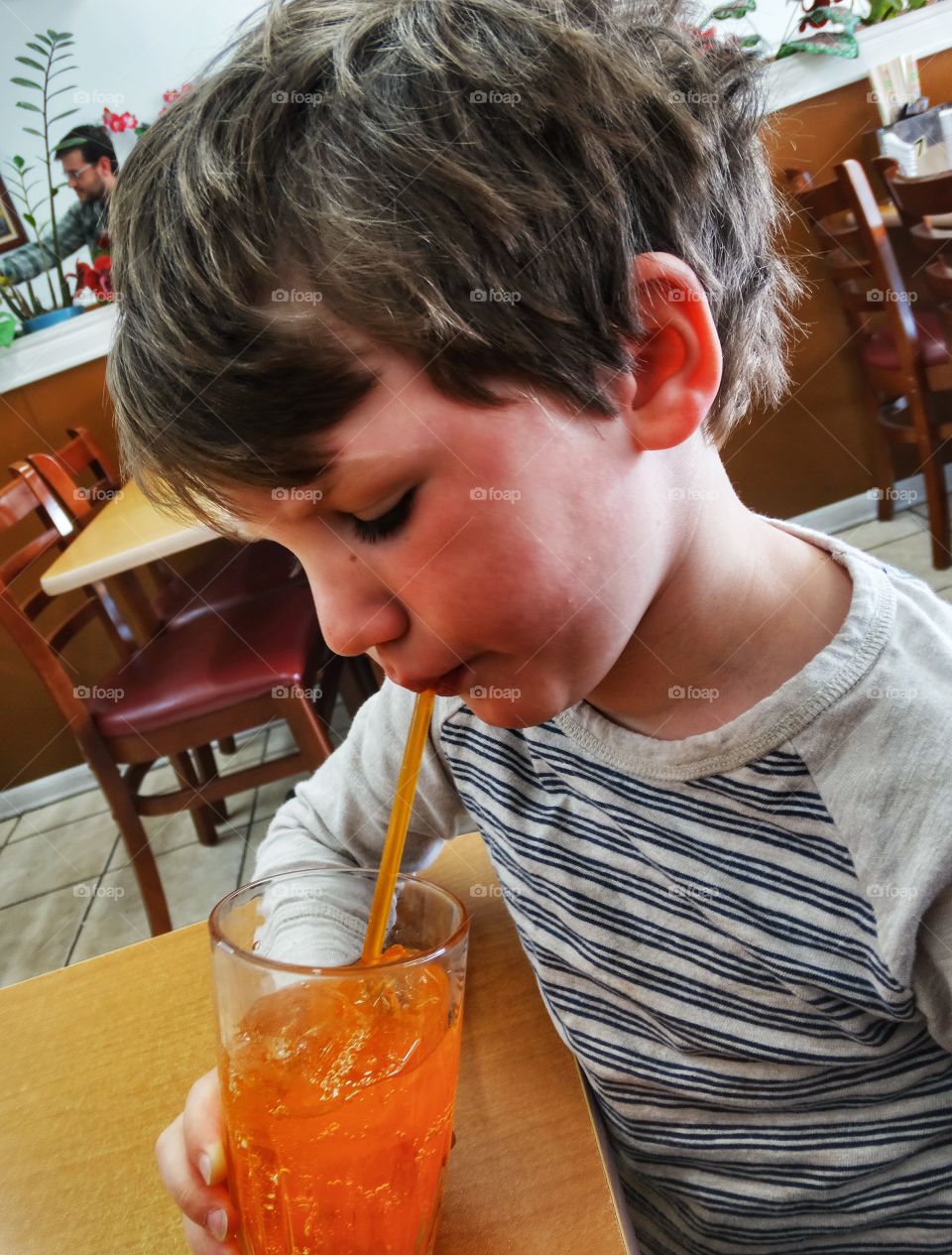 Young Boy Drinking Orange Soda