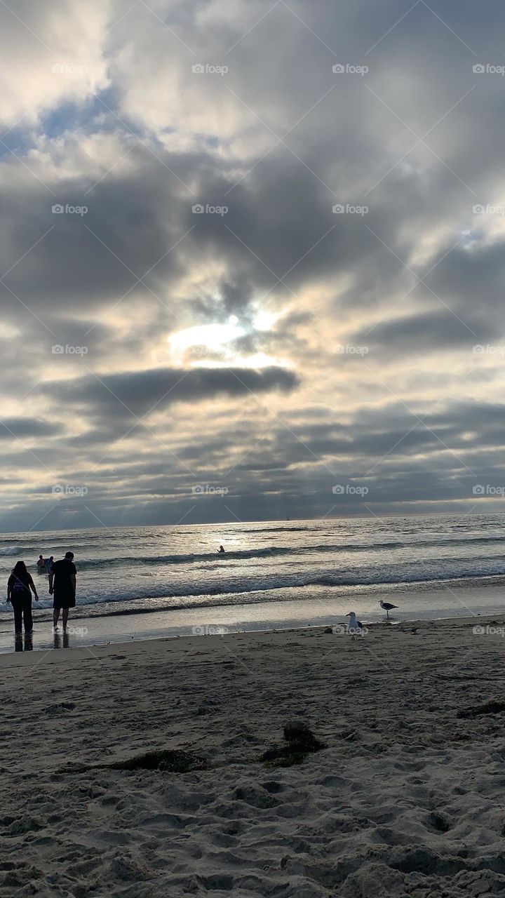 After a day at the beach, the clouds moved in dimming the sun. Night sky will follow. Looks like the clouds meets the ocean at a distance.