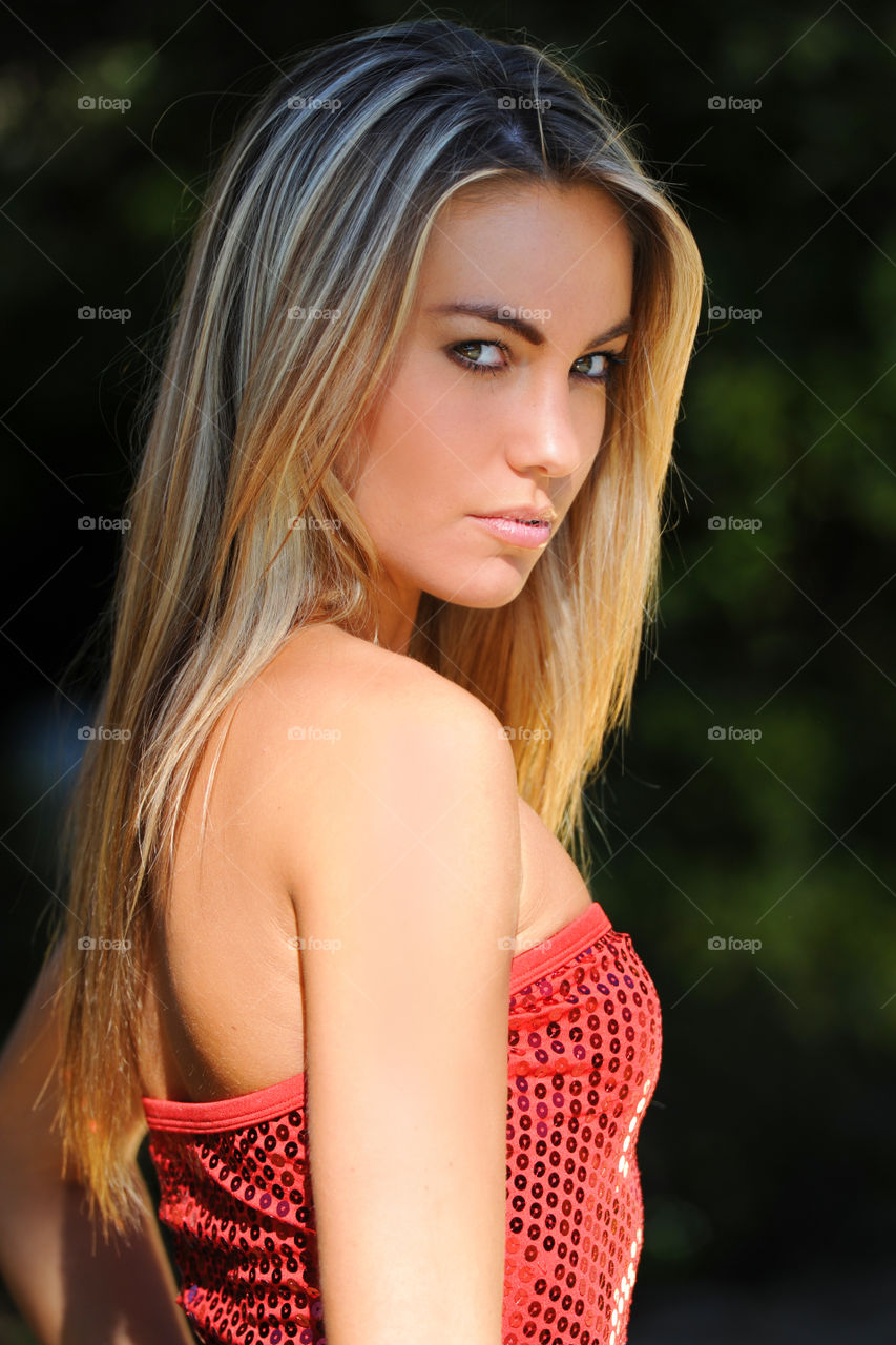 Portrait of young woman in red sequin top