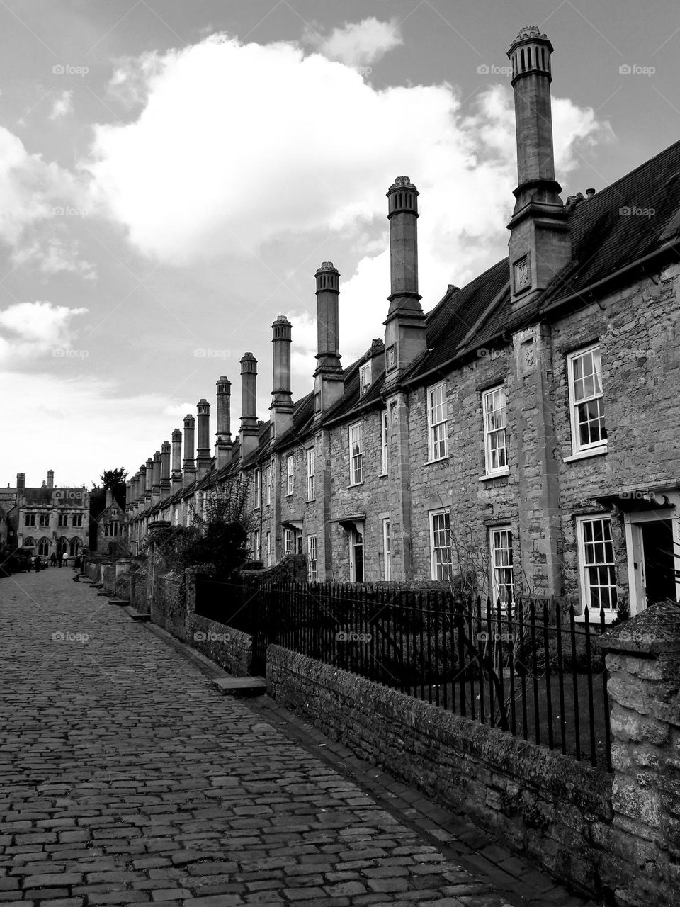 A very Pretty residential street with houses with very tall chimneys