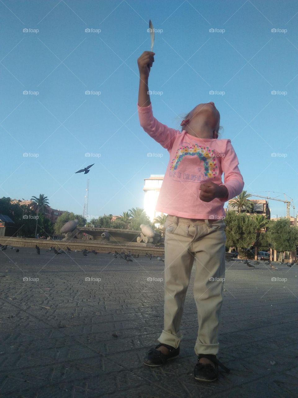 Beautiful young girl looking at the sky.