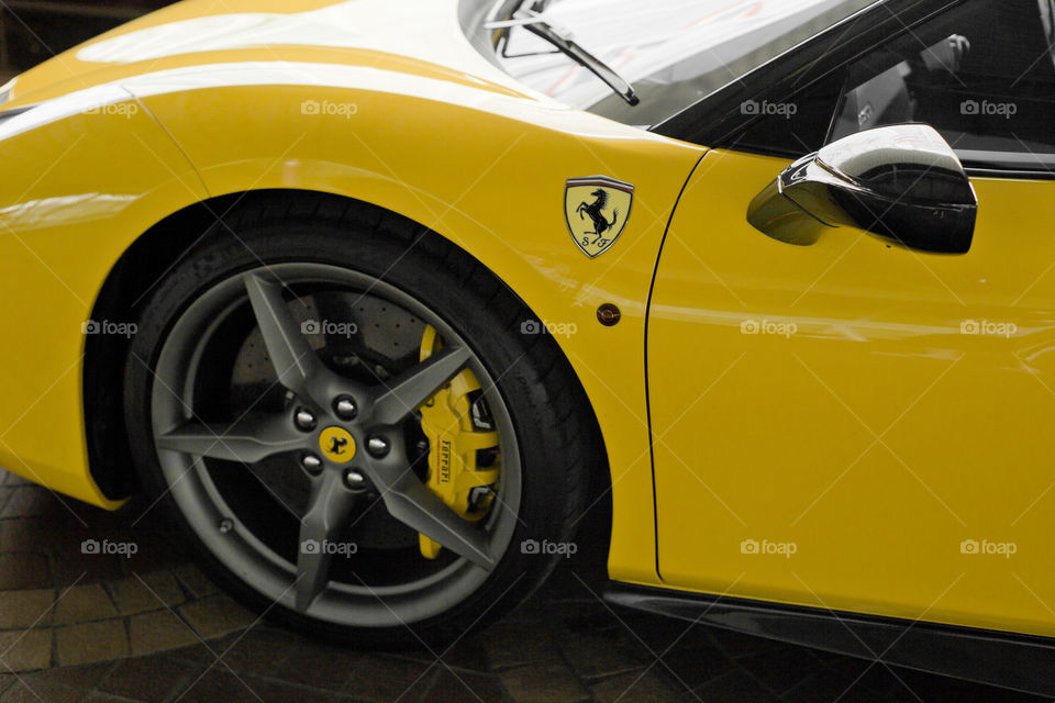 side front wheel and rim close up of Ferrari 488 spider yelow coupe sports car, 3.9 liter V8 twin turbocharged produced by the Italian sports car - Ferrari F154CB V8