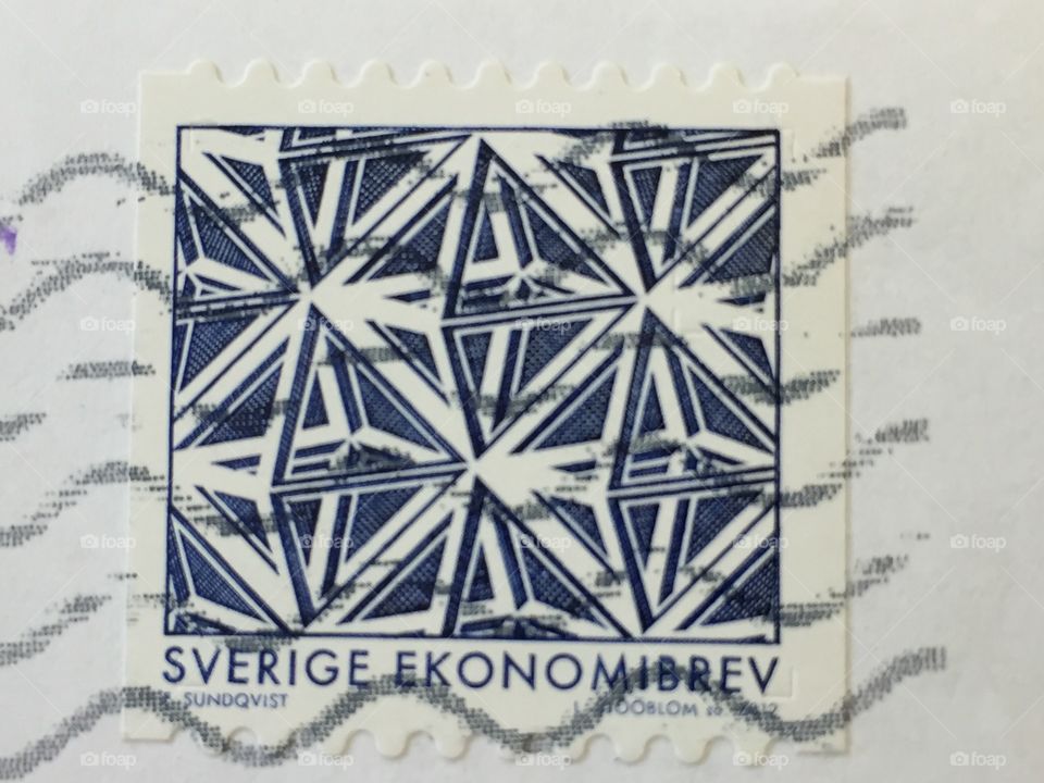 Sweden economy letter stamp showing blue triangular patterns