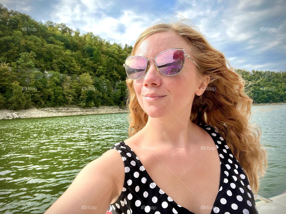 A woman enjoying the last days of summer out on the lake