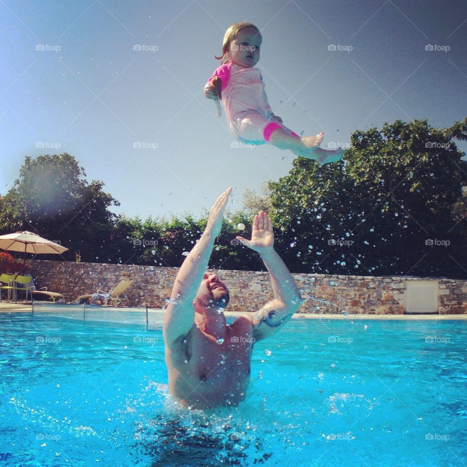 Flying baby . Chloë loves swimming and jumping into the pool. We were on Skopelos enjoying there hotel pool. 