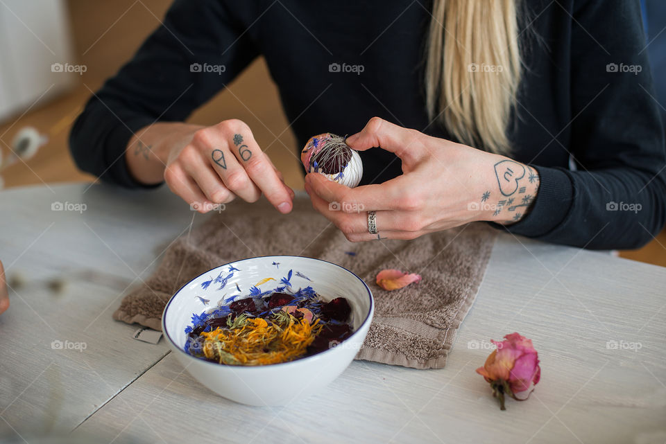 Young woman painting Easter eggs