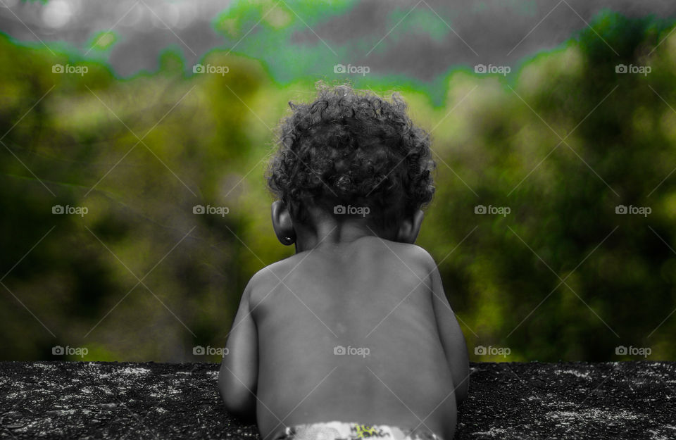Little baby looking out over the cliff