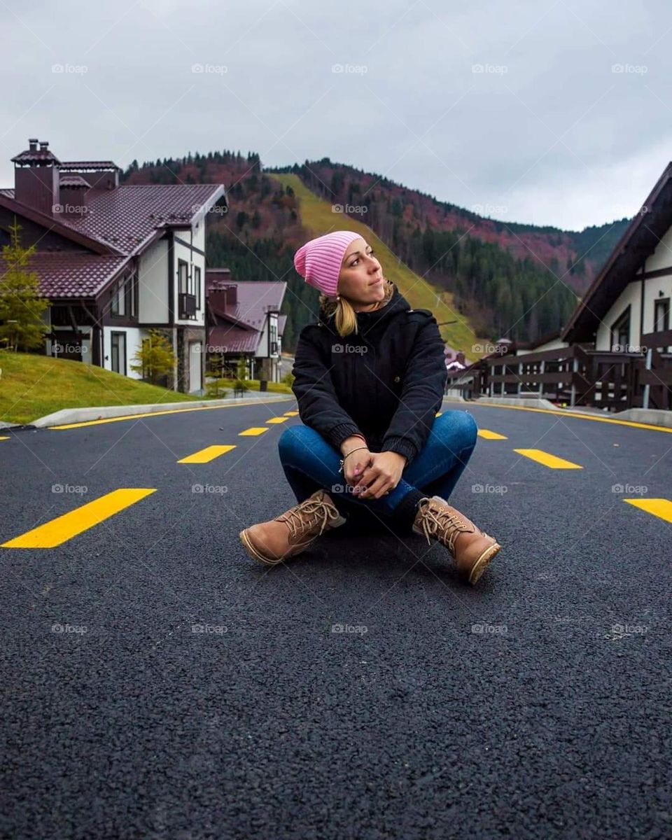 Girl on the road in the mountains