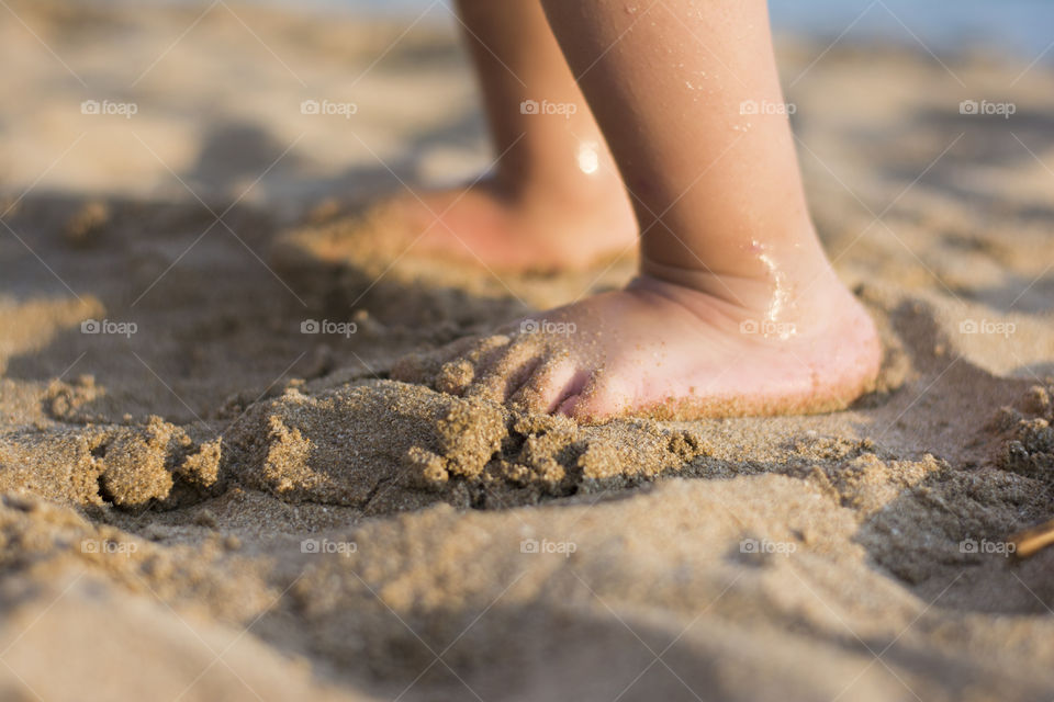 barefoot child in sand. barefoot child in sand on the beach