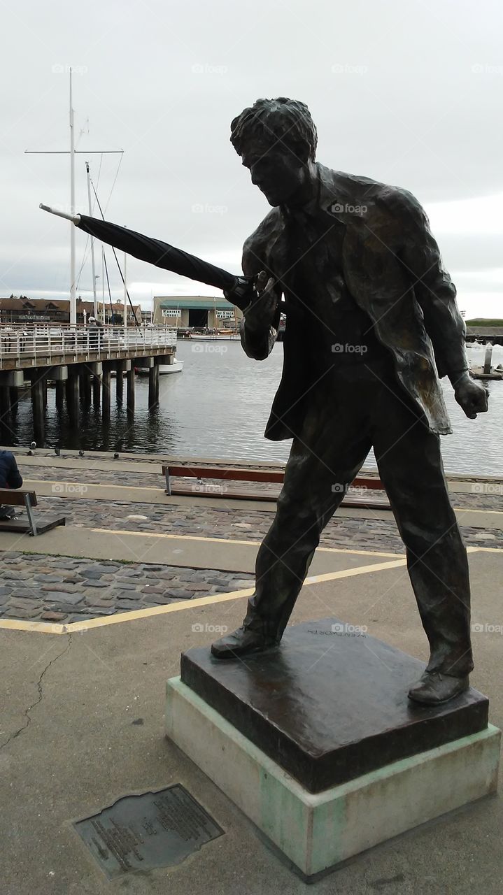 statue holding an umbrella