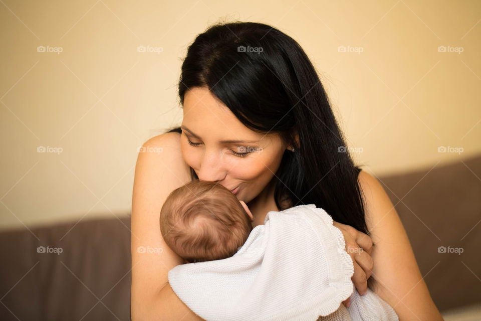 Close-up of a mother kissing her baby