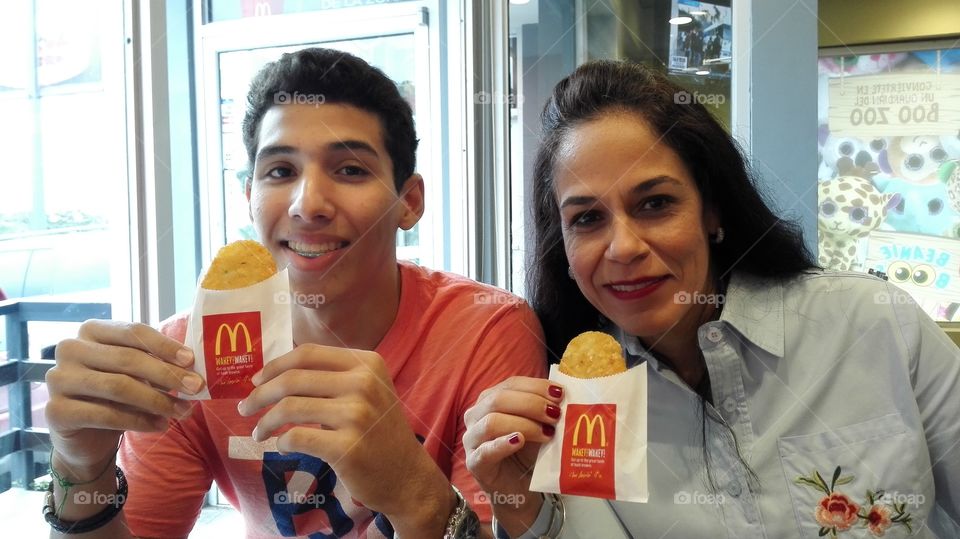 My wife and son enjoying McDonald's hash browns.
