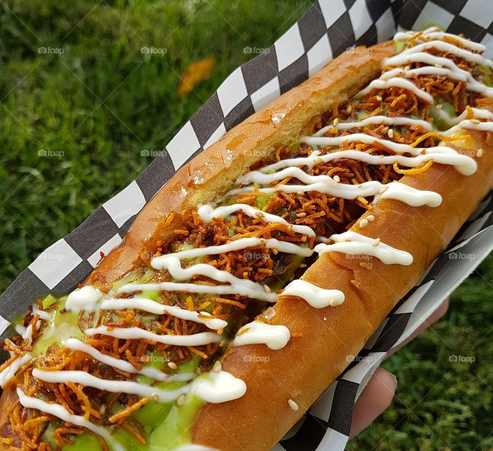 Close-up of person's hand holding street food