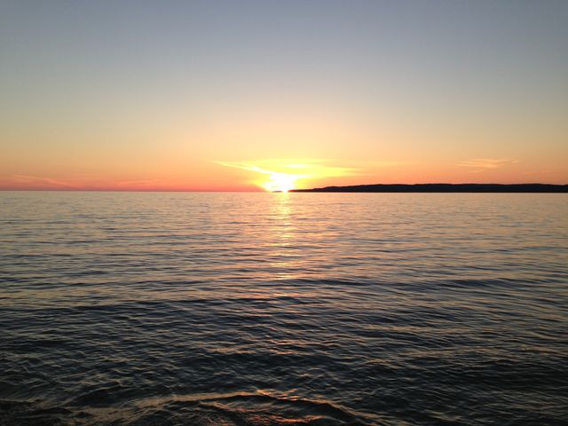 Horizontal . The sun and more of the lake in Michigan's UP