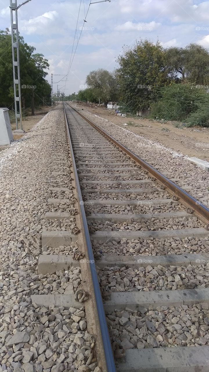 a railway track parallel to each other grit in between the track, concrete solid stone 6