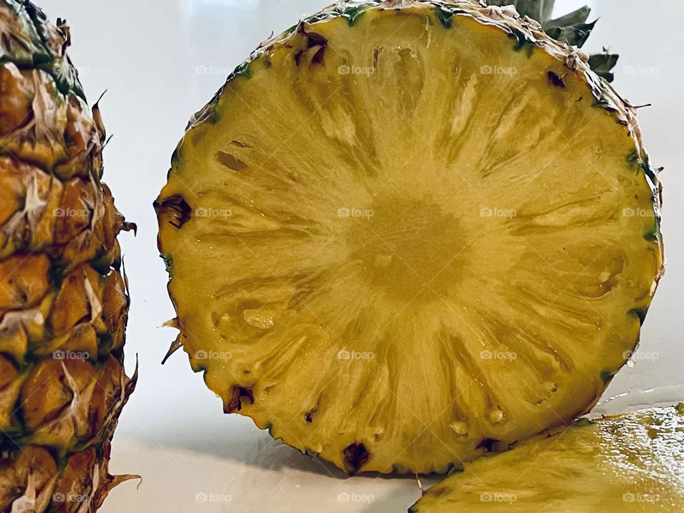 Juicy yellow pineapple slices from above, tropical fruit, Latin American fruit, edible bromeliad 