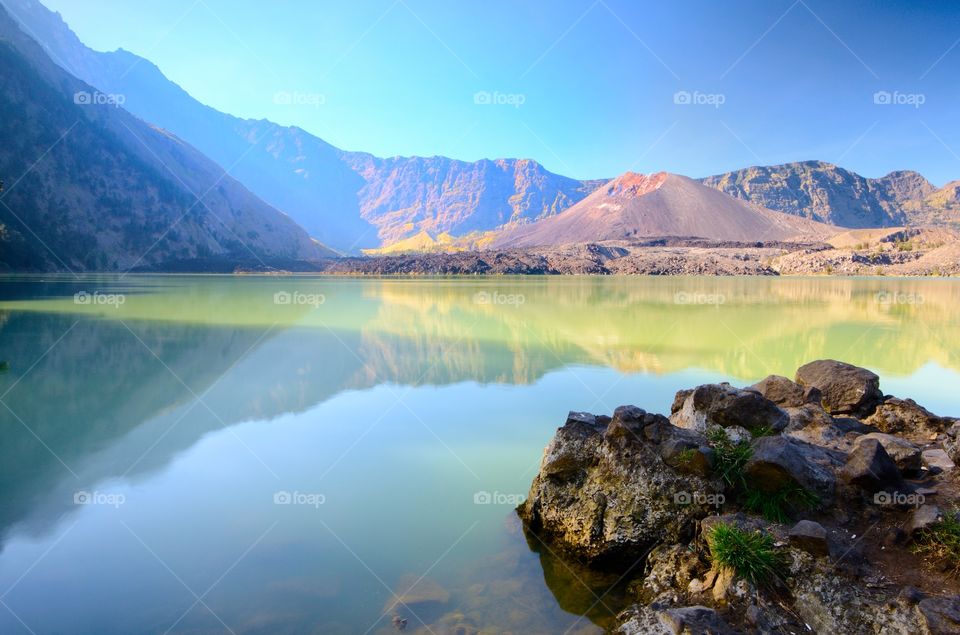 Beautiful nature background Segara Anak Lake in early morning. Mount Rinjani is an active volcano in Lombok, indonesia. Soft focus due to long exposure.