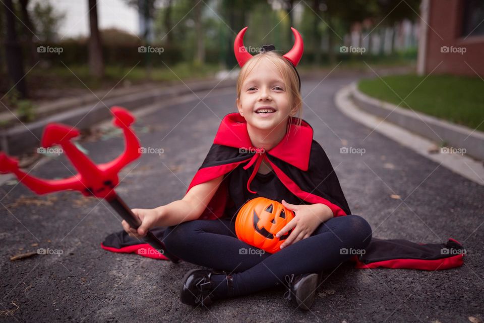 Happy kid celebrating Halloween outdoor 