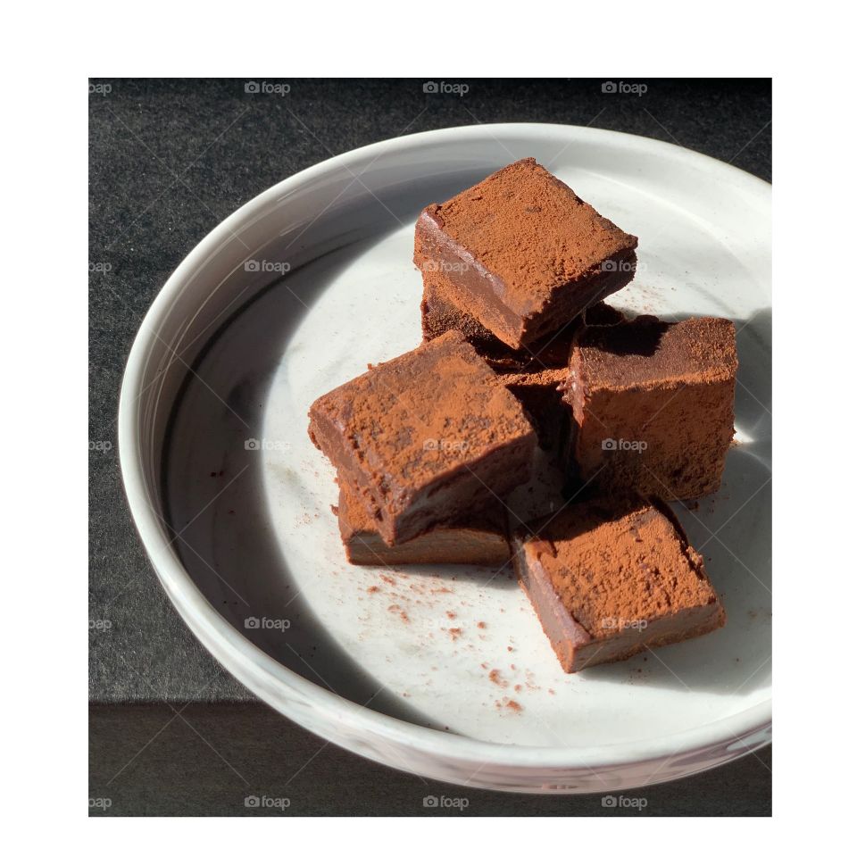 Melt-in-the-mouth soft dark chocolate ganache against dark setting 