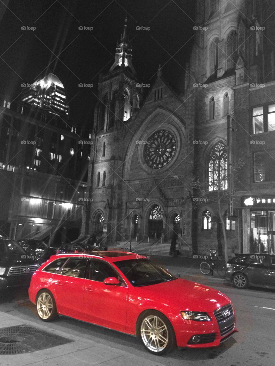 Red car in front of cathedral 
