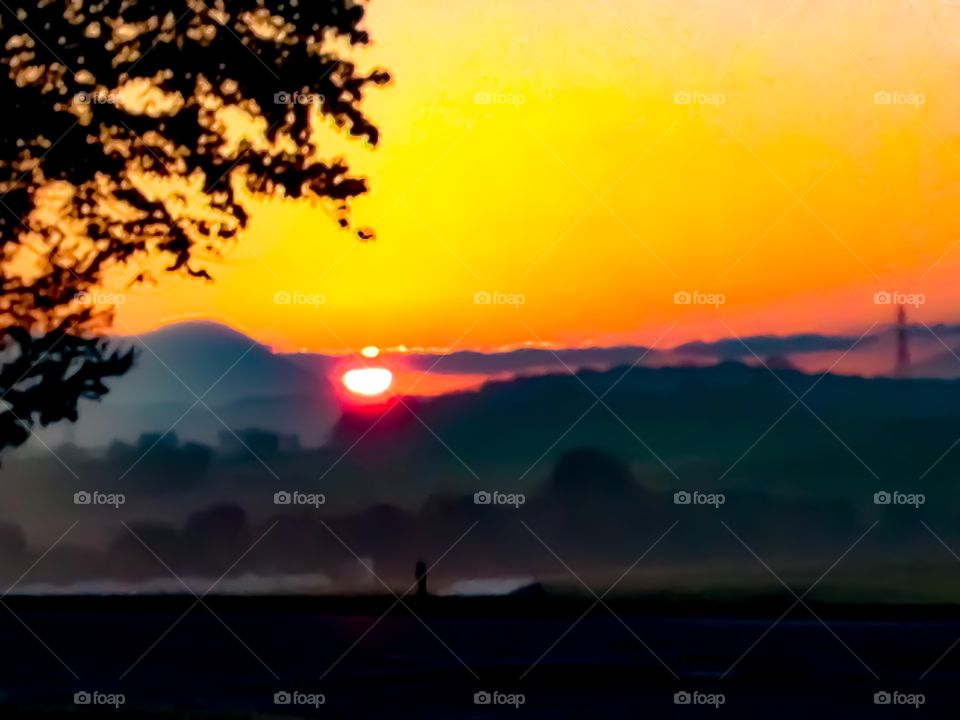 A glorious sunrise in the Shenandoah Valley creating a captivating golden sky with the silhouetted Blue Ridge Mountains in the background. 